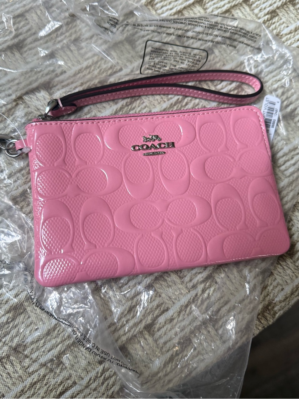 Coach pink leather wristlet with charm
